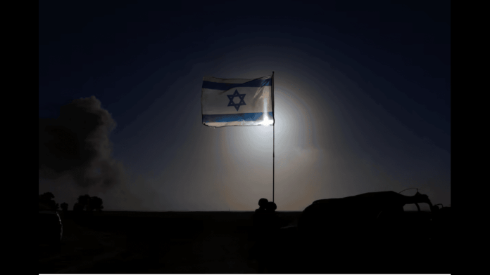 An Israeli flag flies, near the Israel-Gaza border, amid the ongoing conflict between Israel and the Palestinian Islamist group Hamas, in Israel, March 4, 2024. | Reuters